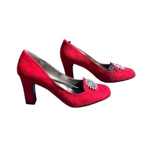 Women’s red suede heels closed toe w jewelry on the toe. By Newport News Size 11
